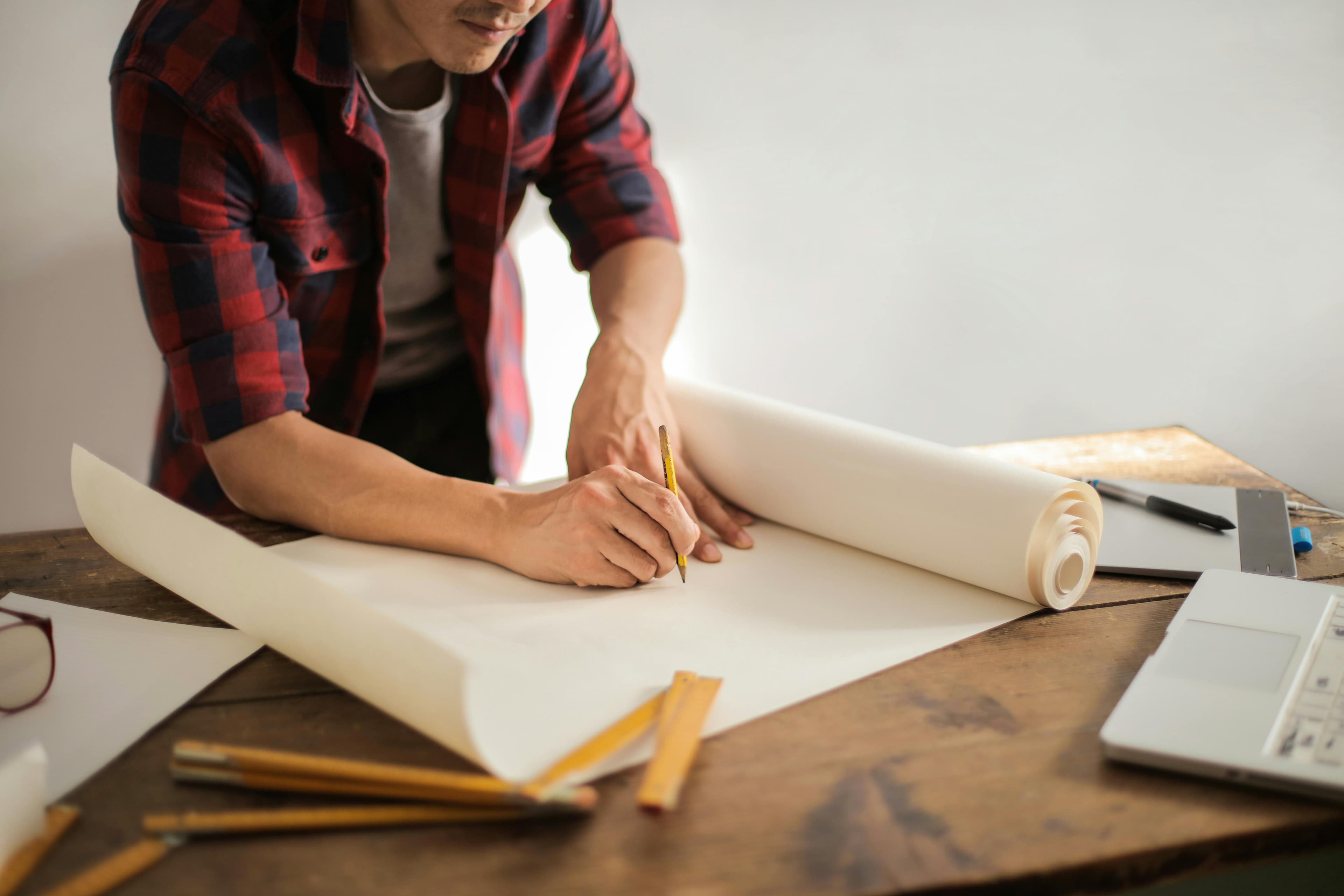 Professional construction worker reviewing blueprints - L&A Construction planning process